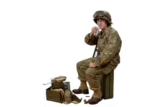 young American soldier in camouflage uniform drink