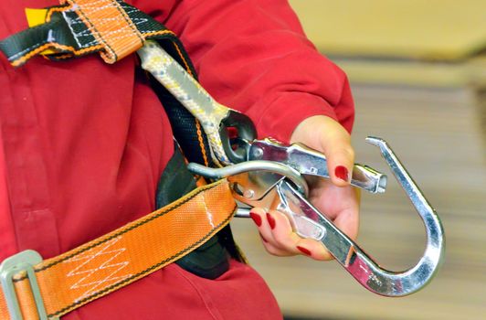 woman and  a fall protection harness inside of factory