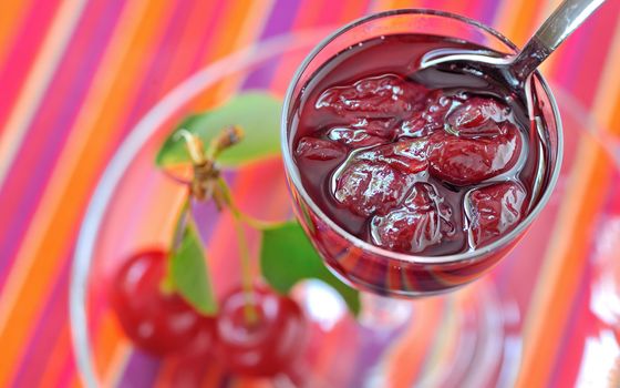 Cherry jam and cheery on plate