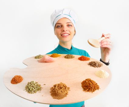Young woman chef and spices