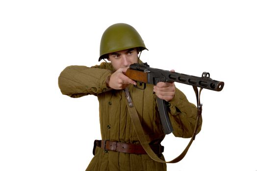 young Soviet soldier shoots with his ppsh 41. He have a helmet