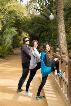 Joggers doing some stretching exercises after a run