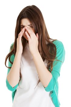 Young beautiful woman with sinus pressure, touching her nose. Isolated on white.