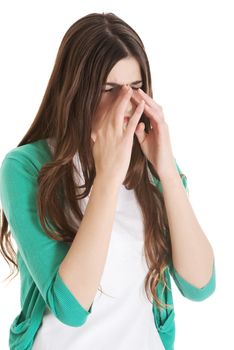 Young beautiful woman with sinus pressure, touching her nose. Isolated on white.