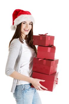 Beautiful woman in santa hat holding presents. Isolated on white.