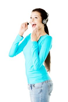 Young casual woman with headphones and microphone. Isolated on white.