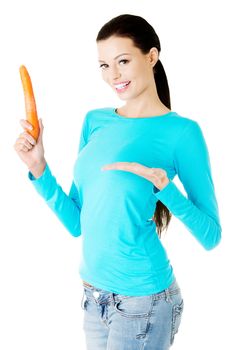 Young beautiful woman holding fresh carrot. Isolated on white.