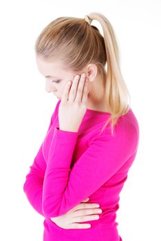 Beautiful casual woman is touching her temples. Isolated on white.