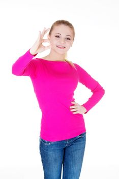 young casual woman student showin OK gesture. Isolated on white.