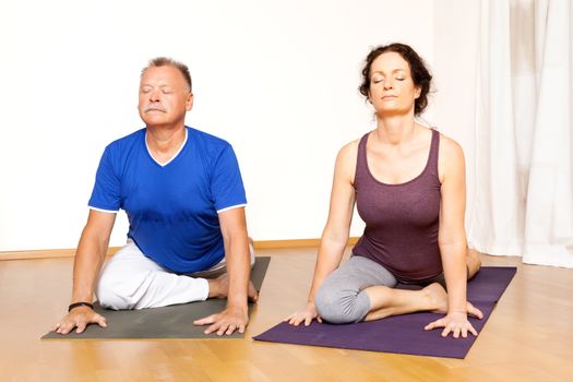 An image of some people doing yoga exercises