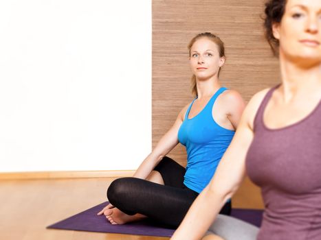 An image of some people doing yoga exercises