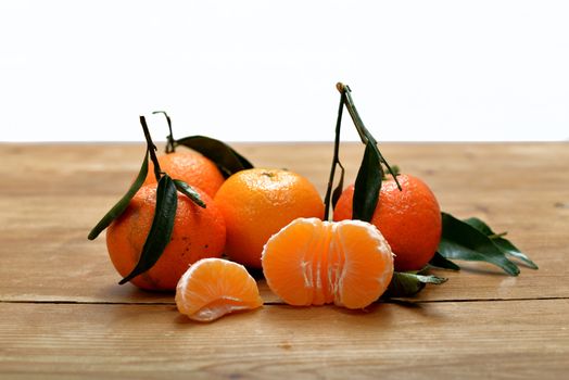 several mandarins placed on a table with white background