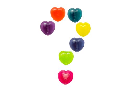 Heart shape confectionery is set in question mark style on white background
