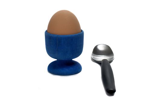 boiled egg in an egg cup with a small spoon