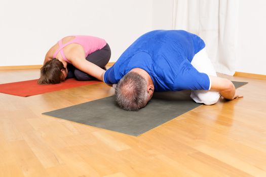 An image of some people doing yoga exercises