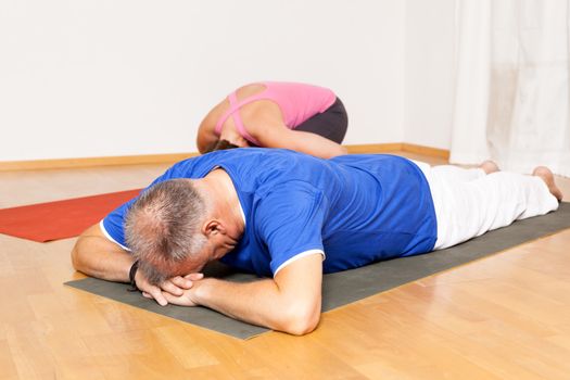 An image of some people doing yoga exercises