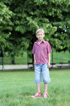 happy boy posing in park