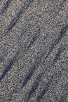 Golden sand with black lines can use as background. Sand from Las Canteras beach. Spain. Canary Islands. Gran Canaria island. Las Palmas de Gran Canaria city. 