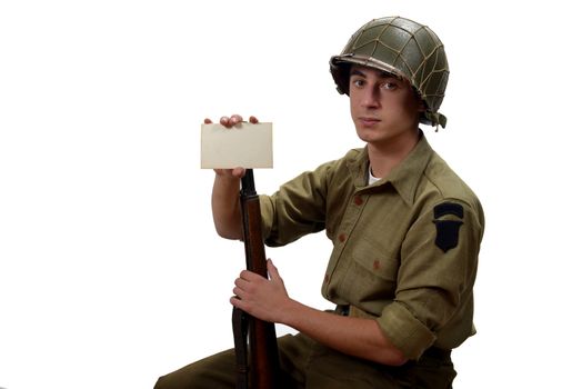 American soldier with his garand M1 and M1 helmet show a photograph