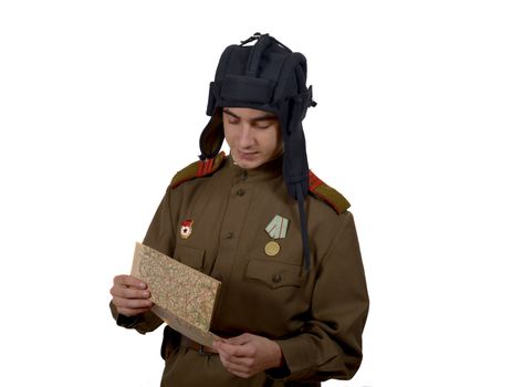 young Soviet tanker look at a map. he have a tanker helmet