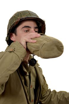 young american soldier drink  water in canteen