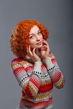 Attractive young girl with red hair in a studio portrait