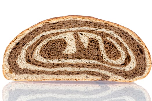 Freshly baked gourmet bi-colour white and brown bread with a decorative spiral pattern on a white background with a reflection