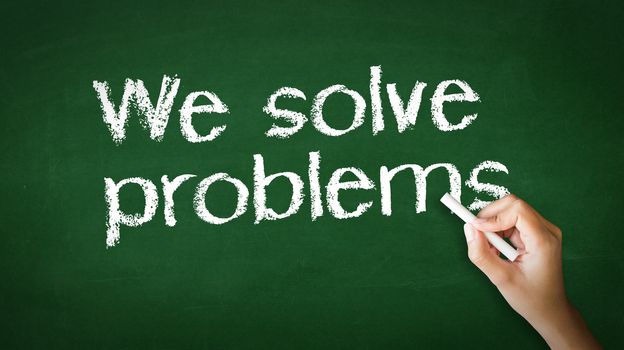 A person drawing and pointing at a We Solve Problems Chalk Illustration