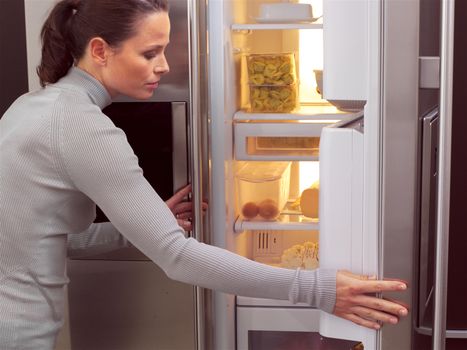 Young woman in front of the fridge