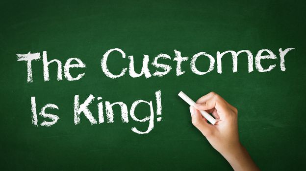 A person drawing and pointing at a Customer is King Chalk Illustration