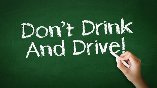 A person drawing and pointing at a Don't Drink And Drive Chalk Illustration