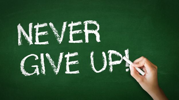 A person drawing and pointing at a Never Give Up Chalk Illustration