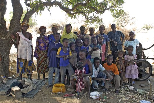 group of African villagers posing for the camera in their village