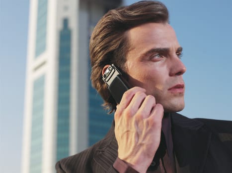 Businessman working near office with mobie phone