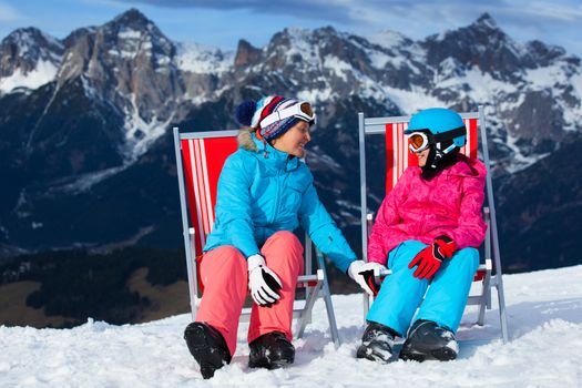 Ski, snow, sun and winter holidays - resting skier in ski resort