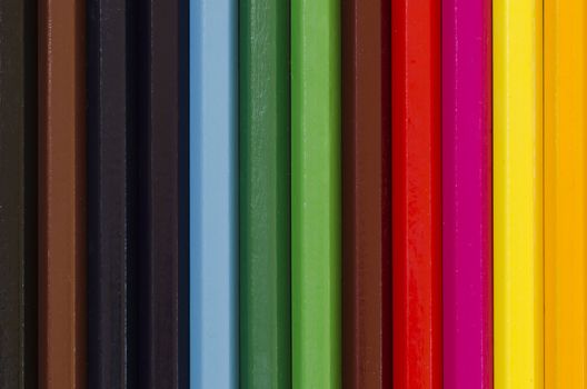 close up of a stack of pencil crayons in many colors creating background