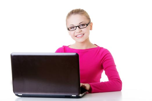 Beautiful young student with laptop. Isolated on white.