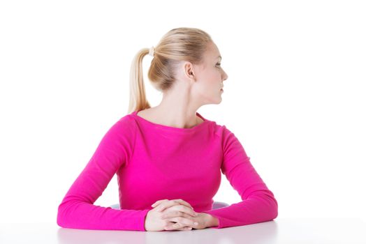 Young beautiful woman's sitting, profile. Isolated on white.