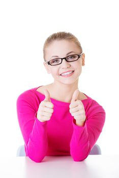 young casual woman student showin OK gesture. Isolated on white.