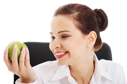 Young beautiful business woman holding an apple. Isolated on white.