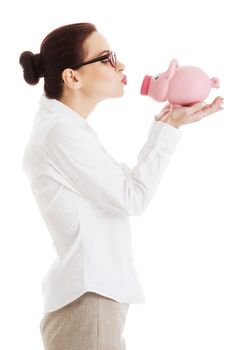 Beautiful business woman holding piggy-bank. Isolated on white.