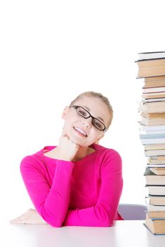 Young happy student with stack of books. Isolated on white.