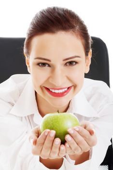 Young beautiful business woman holding an apple. Isolated on white.