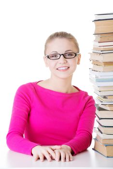 Young happy student with stack of books. Isolated on white.