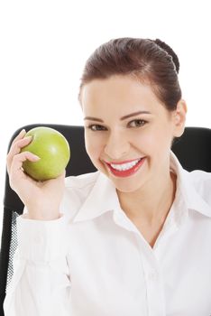 Young beautiful business woman holding an apple. Isolated on white.