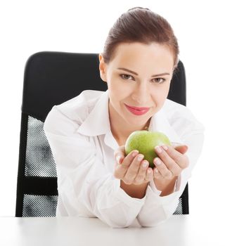 Young beautiful business woman holding an apple. Isolated on white.