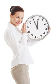 Young beautiful business woman holding clock. Isolated on white.