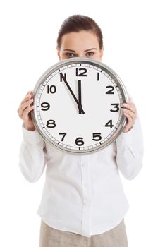 Young beautiful business woman holding clock. Isolated on white.