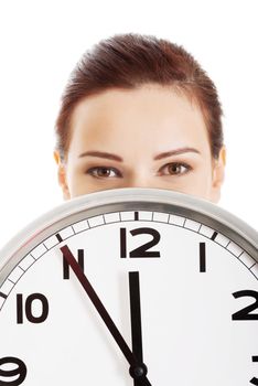 Young beautiful business woman holding clock. Isolated on white.