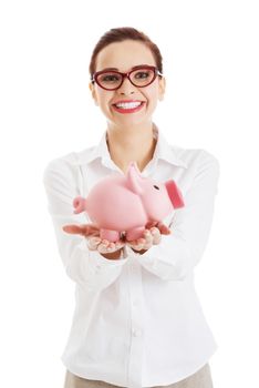 Beautiful business woman holding piggy-bank. Isolated on white.